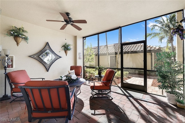 sunroom / solarium with a ceiling fan