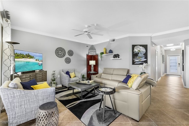 tiled living room featuring visible vents, ornamental molding, and a ceiling fan