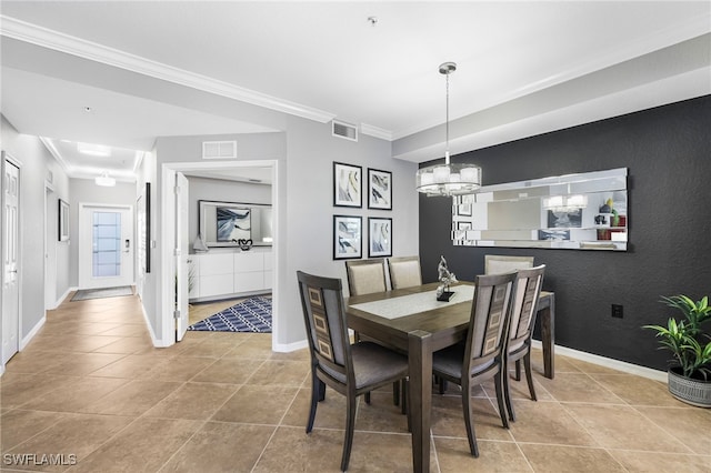 dining room with visible vents, baseboards, and crown molding