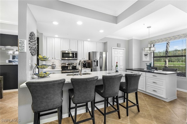 kitchen featuring a sink, ornamental molding, tasteful backsplash, and stainless steel appliances