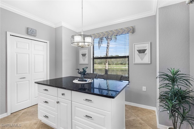 kitchen with crown molding, baseboards, light tile patterned floors, an inviting chandelier, and white cabinets