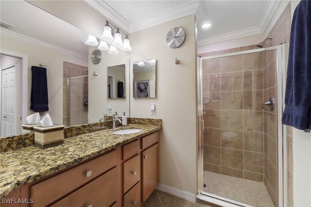 full bathroom featuring tile patterned floors, a stall shower, vanity, and crown molding