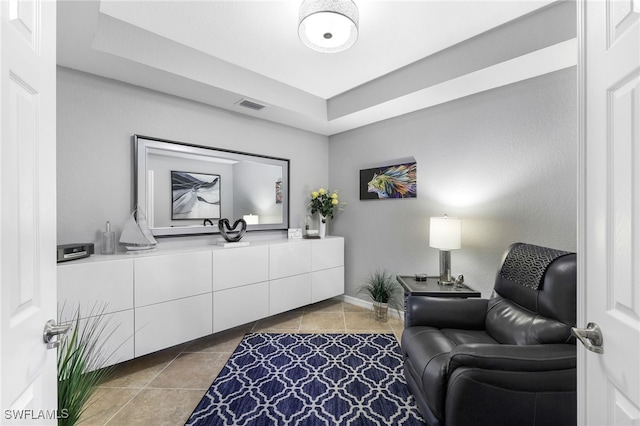 living area featuring tile patterned floors and visible vents