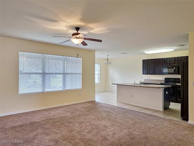 kitchen featuring an island with sink, black appliances, open floor plan, ceiling fan with notable chandelier, and light colored carpet