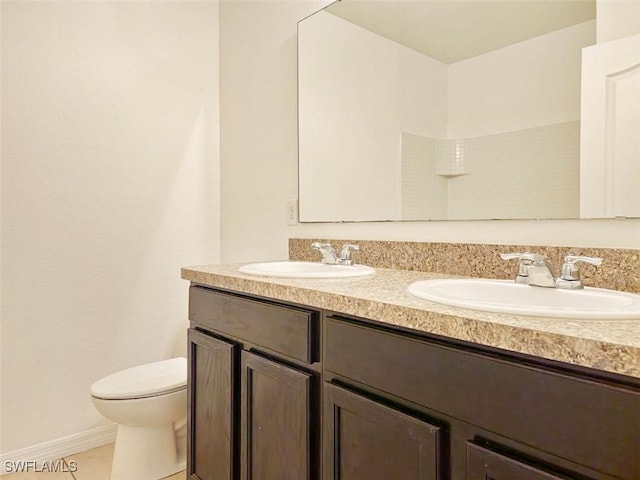 full bathroom with tile patterned flooring, double vanity, toilet, and a sink