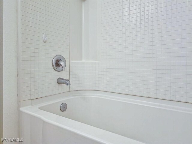 full bathroom with a bathing tub