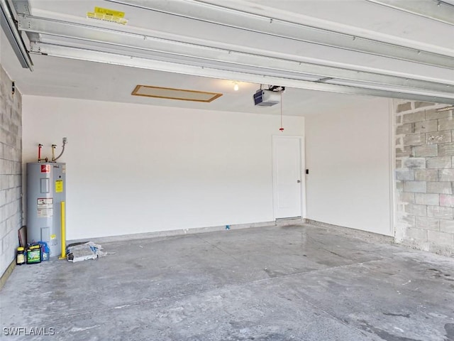 garage featuring concrete block wall, a garage door opener, and electric water heater