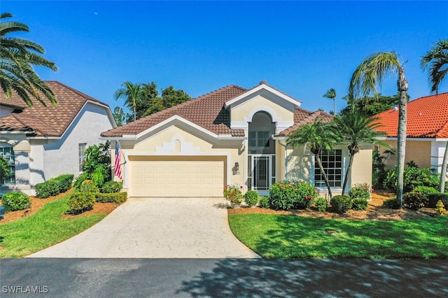 mediterranean / spanish house featuring stucco siding, a tiled roof, concrete driveway, and a garage