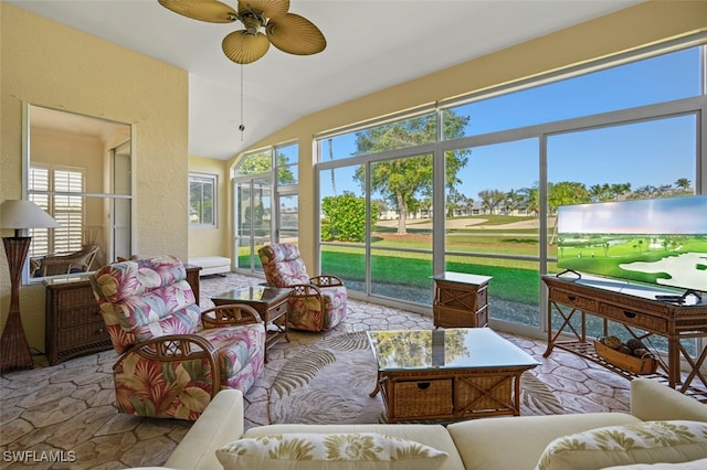 sunroom featuring a ceiling fan and vaulted ceiling