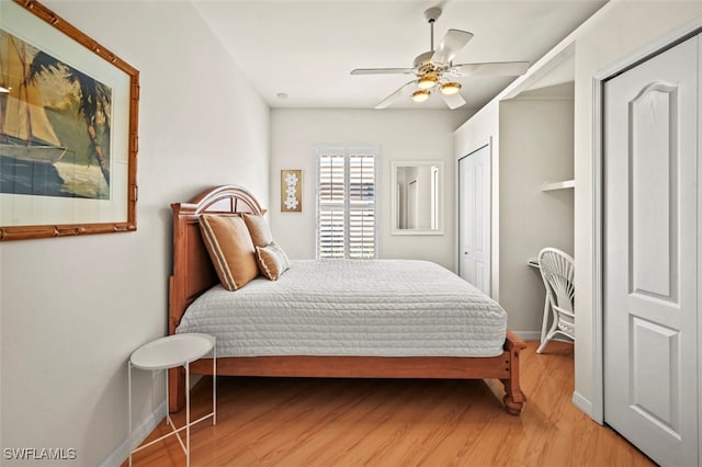 bedroom featuring baseboards, light wood-style flooring, and a ceiling fan