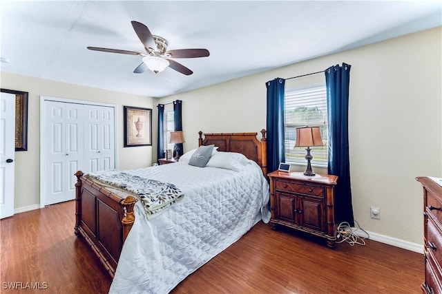 bedroom with a closet, baseboards, dark wood-type flooring, and a ceiling fan