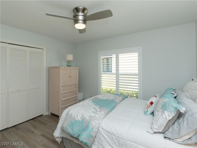 bedroom featuring a closet, wood finished floors, and a ceiling fan