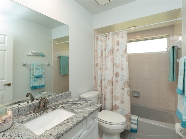 bathroom featuring toilet, vanity, and shower / bath combo