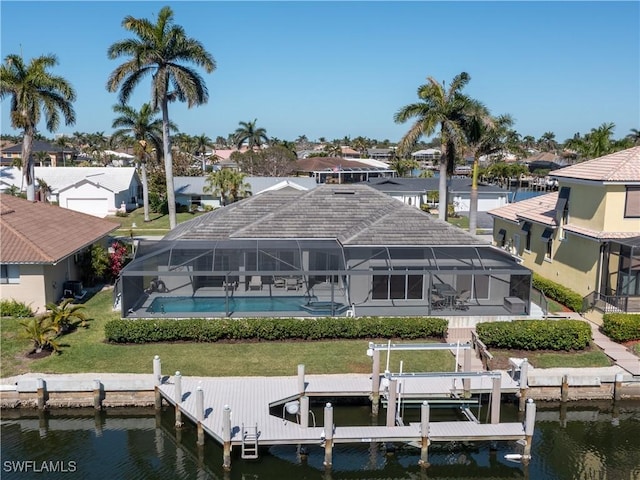 dock area with an outdoor pool, a water view, a residential view, and boat lift