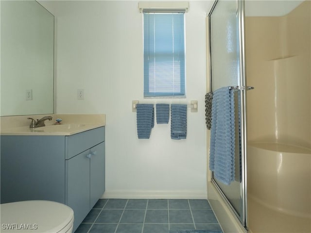 full bathroom with baseboards, toilet, a shower with shower door, tile patterned floors, and vanity