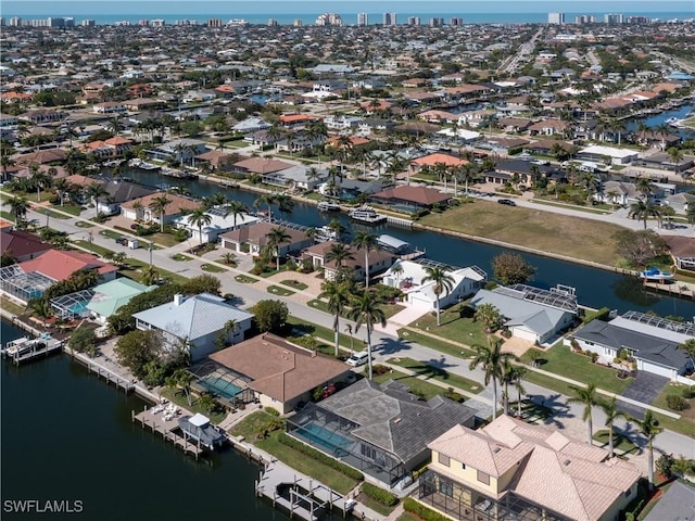 drone / aerial view featuring a residential view and a water view