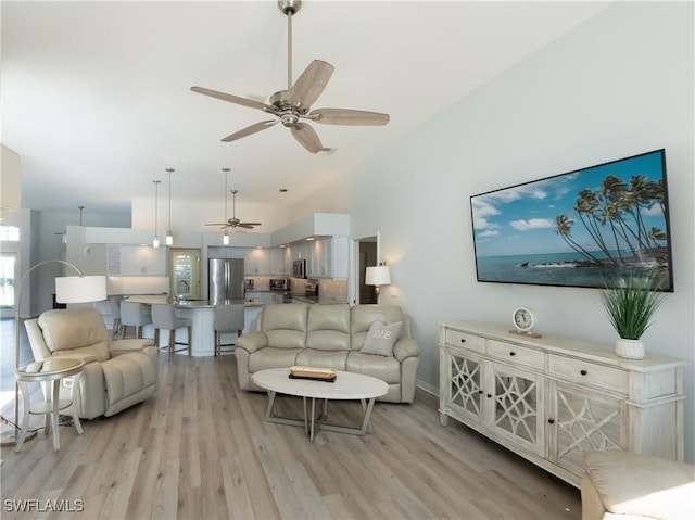 living room featuring a ceiling fan and light wood-type flooring