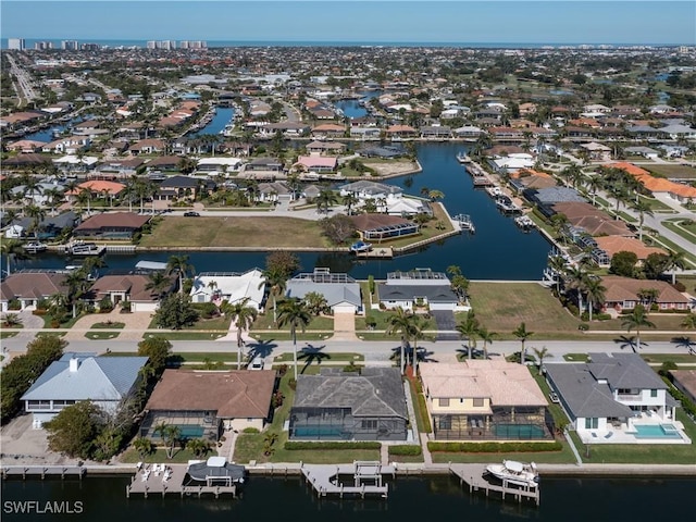 drone / aerial view with a residential view and a water view