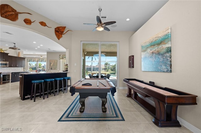 playroom featuring billiards, visible vents, light tile patterned flooring, arched walkways, and ceiling fan