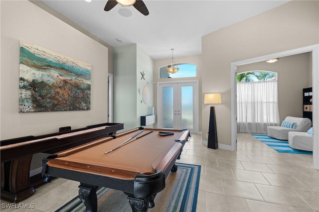 playroom with tile patterned flooring, a ceiling fan, french doors, and a healthy amount of sunlight