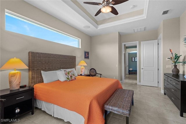 bedroom featuring visible vents, a raised ceiling, and a ceiling fan