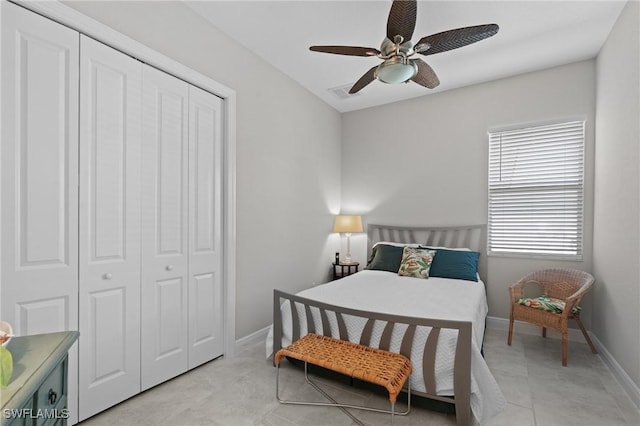 bedroom featuring light tile patterned floors, a ceiling fan, visible vents, baseboards, and a closet