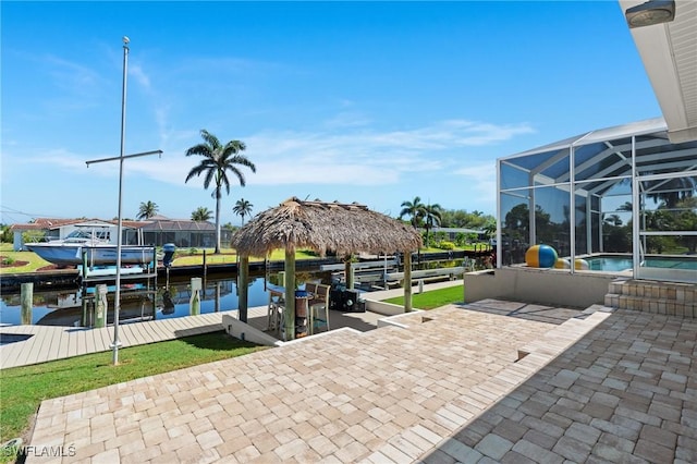 view of patio with glass enclosure, a boat dock, an outdoor pool, a water view, and boat lift