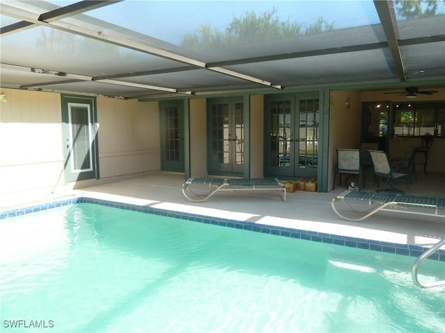 pool featuring french doors, a patio, ceiling fan, and glass enclosure