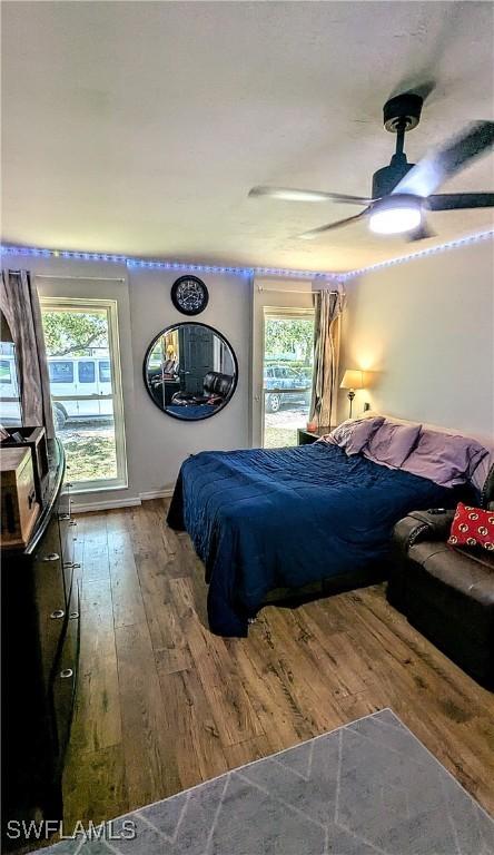 bedroom featuring wood-type flooring and multiple windows