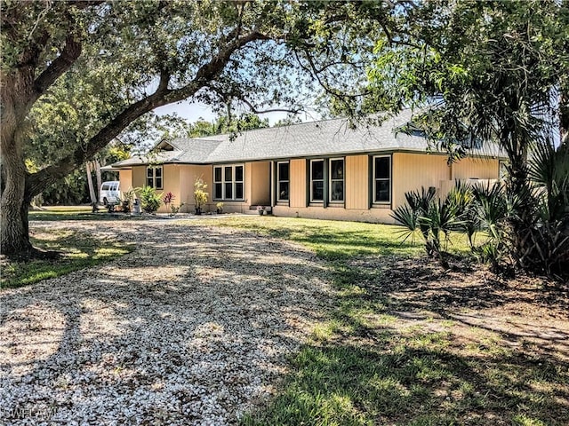 rear view of property with a yard