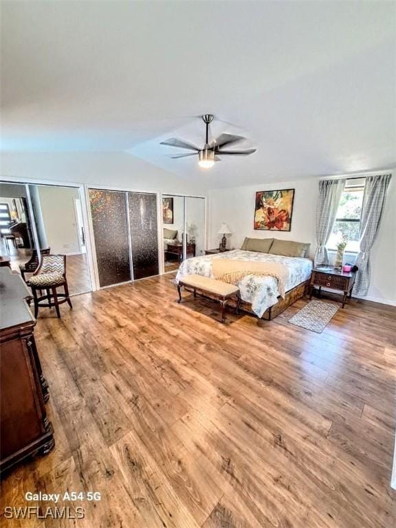 bedroom featuring a ceiling fan, vaulted ceiling, and wood finished floors
