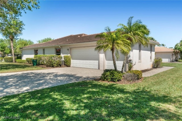 3966 Recreation Ln, Naples, FL 34116 - view of property exterior featuring stucco siding, a yard, a garage, decorative driveway, and a tile roof