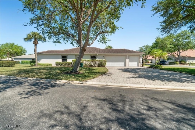 3966 Recreation Ln, Naples, FL 34116 - single story home with a garage, driveway, a front yard, and stucco siding