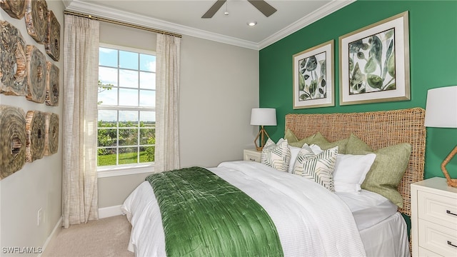 bedroom with a ceiling fan, baseboards, carpet, and crown molding