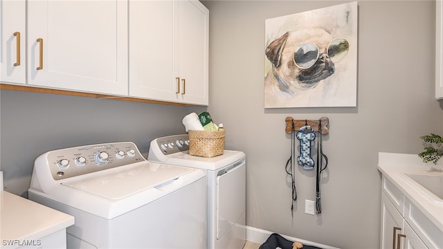 laundry area featuring cabinet space and washer and clothes dryer