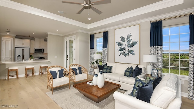 living room with baseboards, recessed lighting, ceiling fan, ornamental molding, and light wood-type flooring