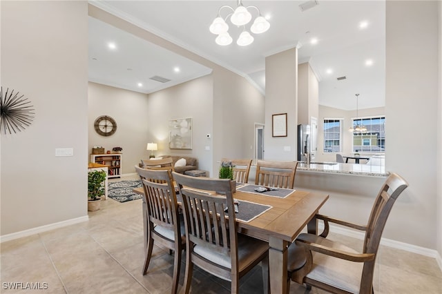 dining room with crown molding, light tile patterned floors, visible vents, and a chandelier