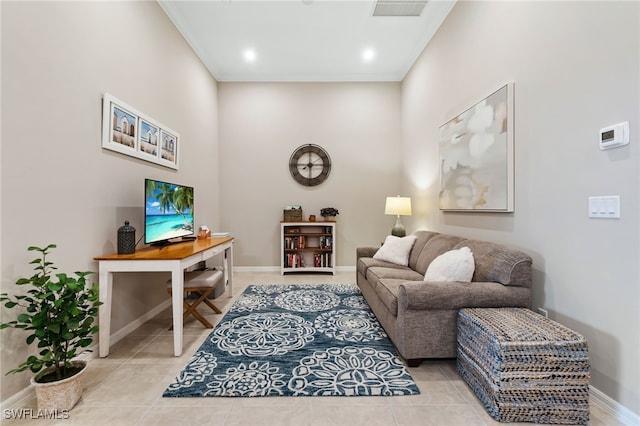 living area with light tile patterned floors, visible vents, baseboards, and crown molding