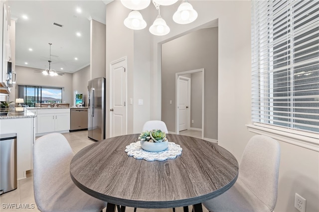 dining room with light tile patterned floors, visible vents, a high ceiling, recessed lighting, and a chandelier