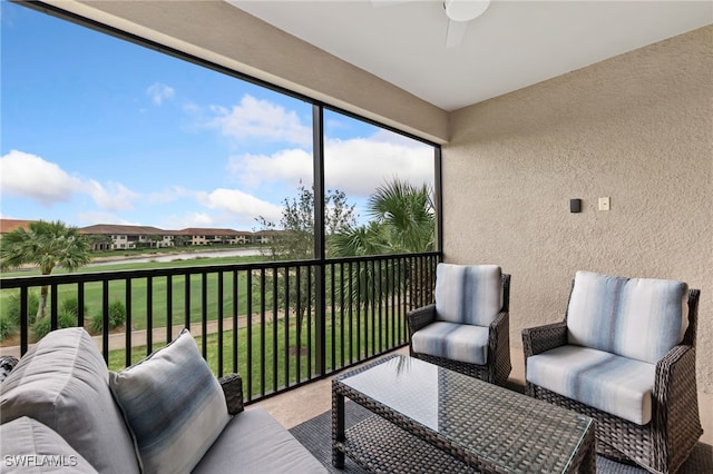 sunroom featuring a ceiling fan