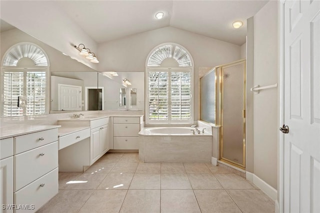 bathroom featuring tile patterned flooring, a garden tub, vaulted ceiling, a stall shower, and vanity