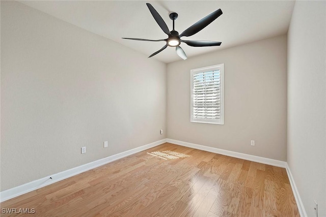 spare room featuring baseboards, a ceiling fan, and light wood finished floors