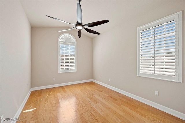 unfurnished room with a ceiling fan, baseboards, and light wood finished floors