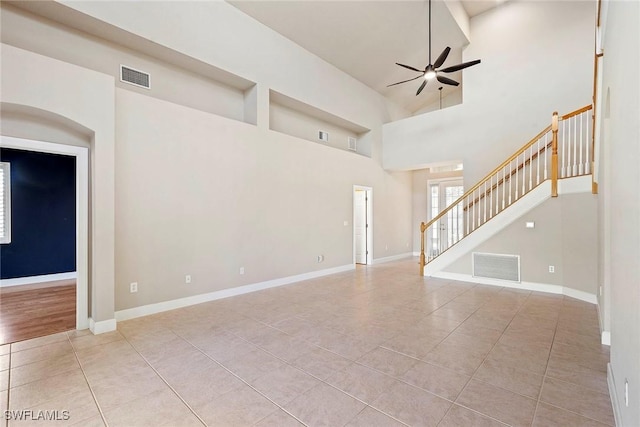 unfurnished room featuring visible vents, baseboards, stairs, and ceiling fan