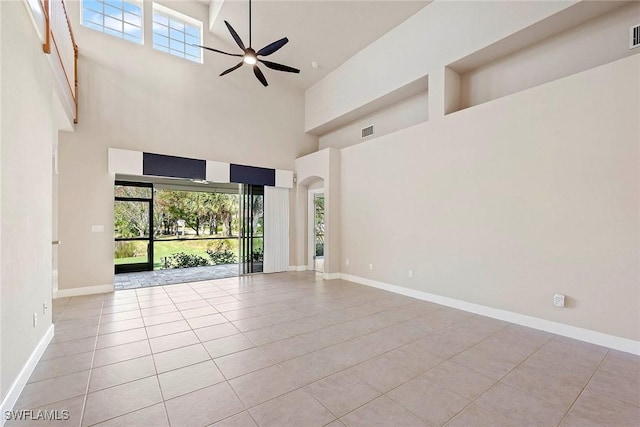 unfurnished room featuring visible vents, arched walkways, a healthy amount of sunlight, and a ceiling fan