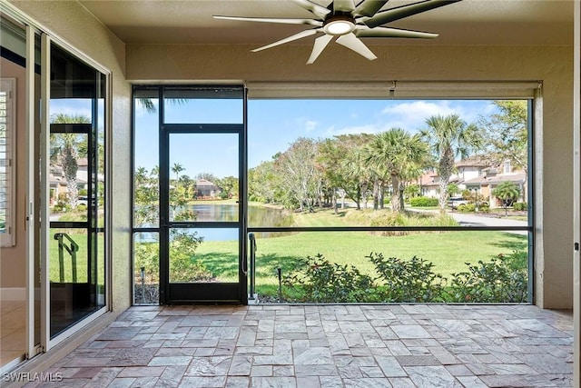 unfurnished sunroom featuring a ceiling fan