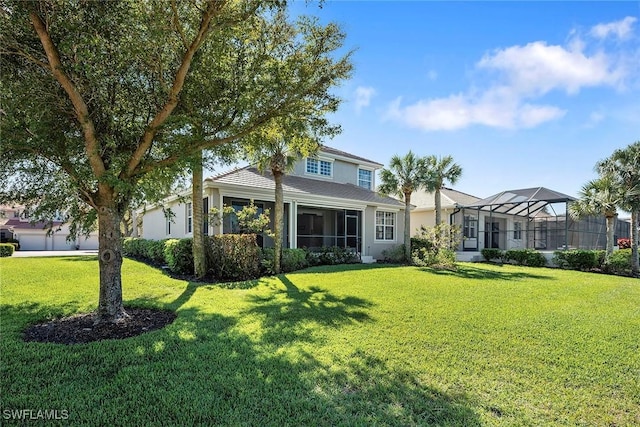 view of front of home featuring glass enclosure, a front lawn, and stucco siding