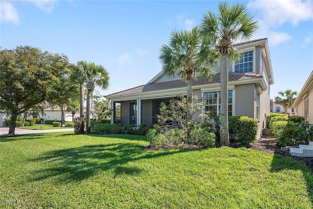 view of front of property with stucco siding and a front yard