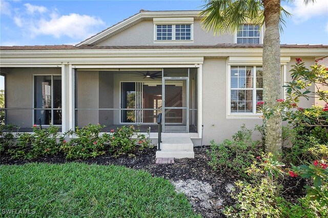 exterior space featuring stucco siding and a sunroom