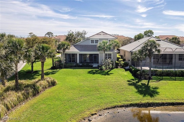 view of front of property with a lanai, stucco siding, and a front yard